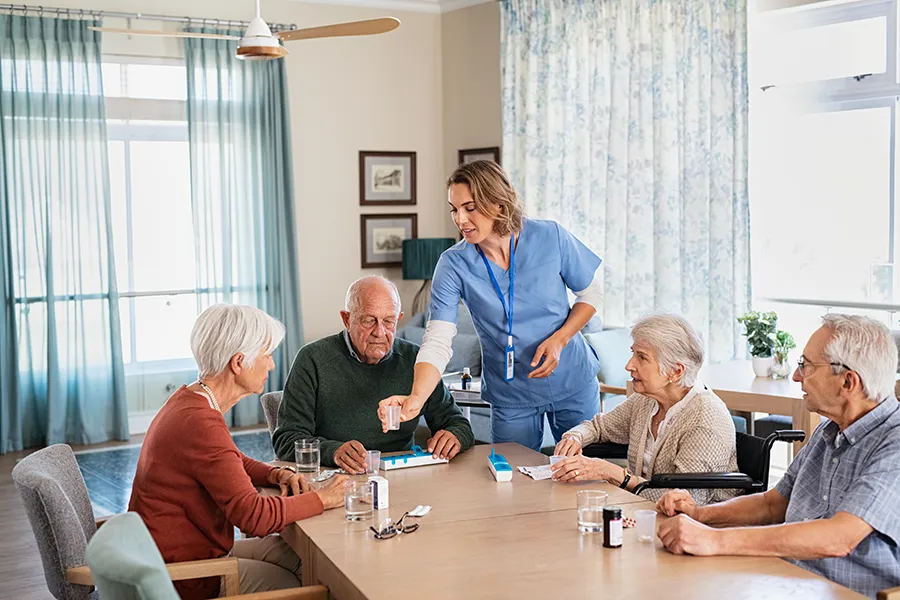 Nursing Home - Fox Valley Medical Associates nurse-giving-daily-medicine-to-seniors-at-nursing-home
